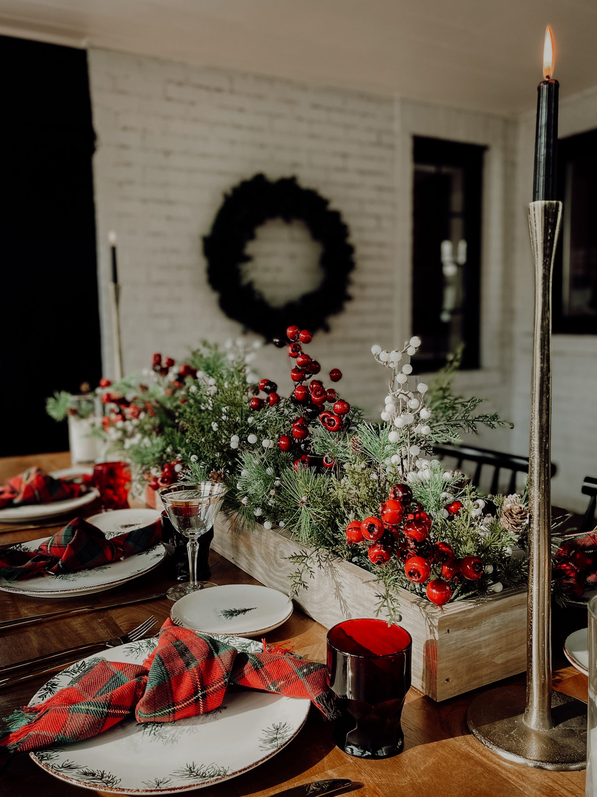 A traditional Christmas dining room with a modern twist featuring Tartan Plaid, pops of black and pine tree accents. 

See more on
www.mirandaschroeder.com