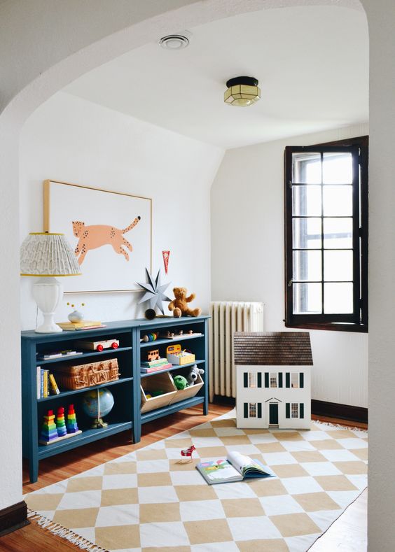 Clean, white kids playroom ideas with pops of black and blue. 